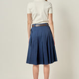 Straight-on rear view of a navy blue pleated midi skirt showing the continuous knife pleat construction and waist belt loops.