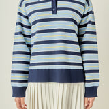 Upper body close-up view of a navy multi striped polo knit dress highlighting the dark blue collar and front button placket.