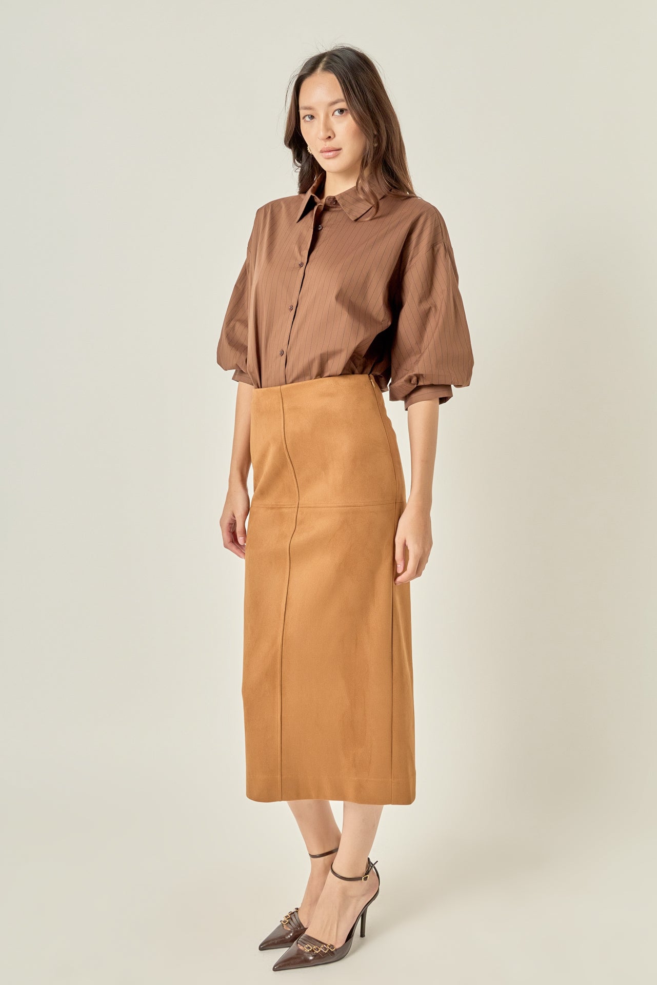 Full-length three-quarter view of a brown pinstripe balloon sleeve shirt showcasing the sleeve volume and tailored collar.