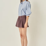 Full-length side profile view of a dusty blue striped balloon sleeve shirt showing the sleeve volume and relaxed side seam.